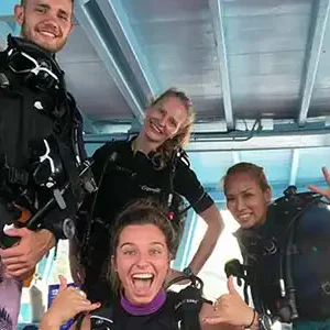 fun diving trips koh tao divers and guide happy on the boat at Crystal Dive