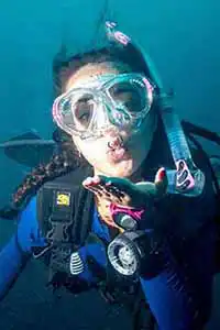 Scuba diver blowing kiss underwater