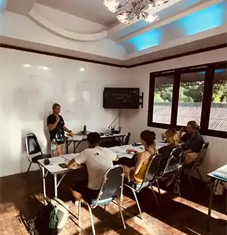 Instructor presenting theory to students in Crystal Dive classroom