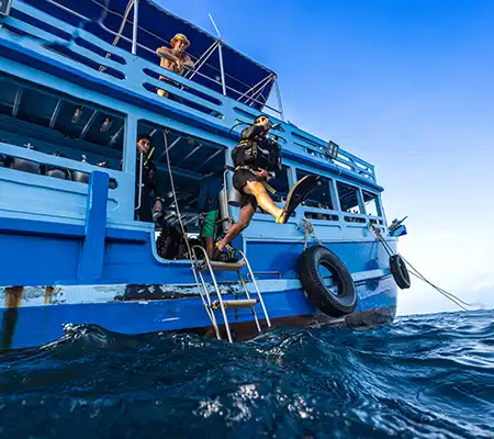 Scuba diver cleaning superyacht