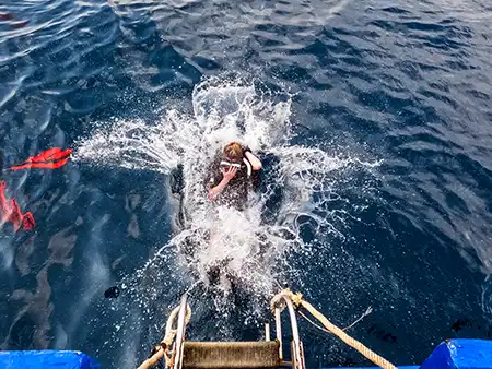 Diver does deep water back entry from Crystal Dive boat on Koh Tao Thailand