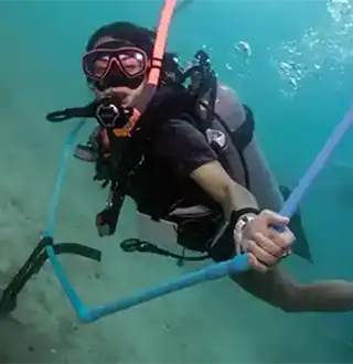 Crystal Dive Perfect Buoyancy Specialty diver playing with underwater hoop