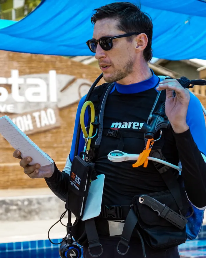 assistant instructor trainer course candidate briefing next to the pool