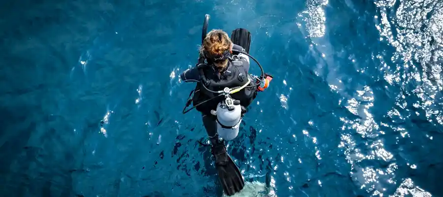 A diver entering the water from above