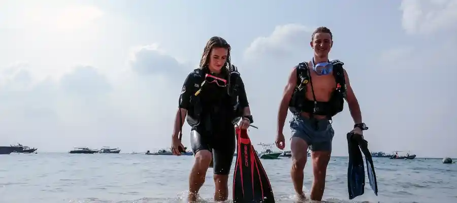 Happy divers finishing their shore dive