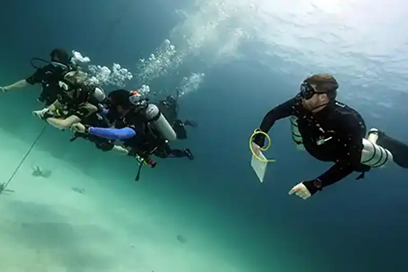 Crystal Dive Instructor evaluating student compass skill in the water on Koh Tao
