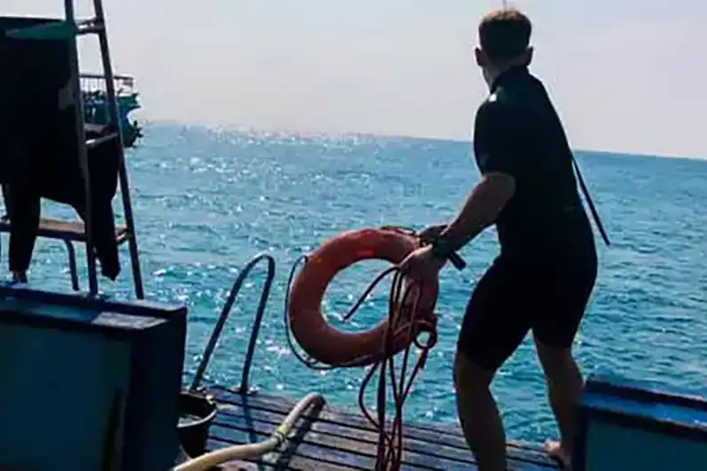 Stress and Rescue Course student seen throwing flotation device from the Crystal Dive boat
