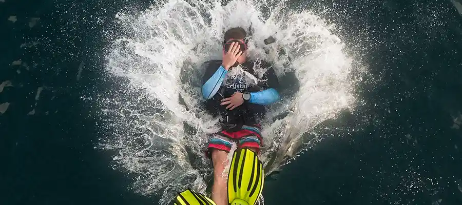 Diver entering the water from the dive boat